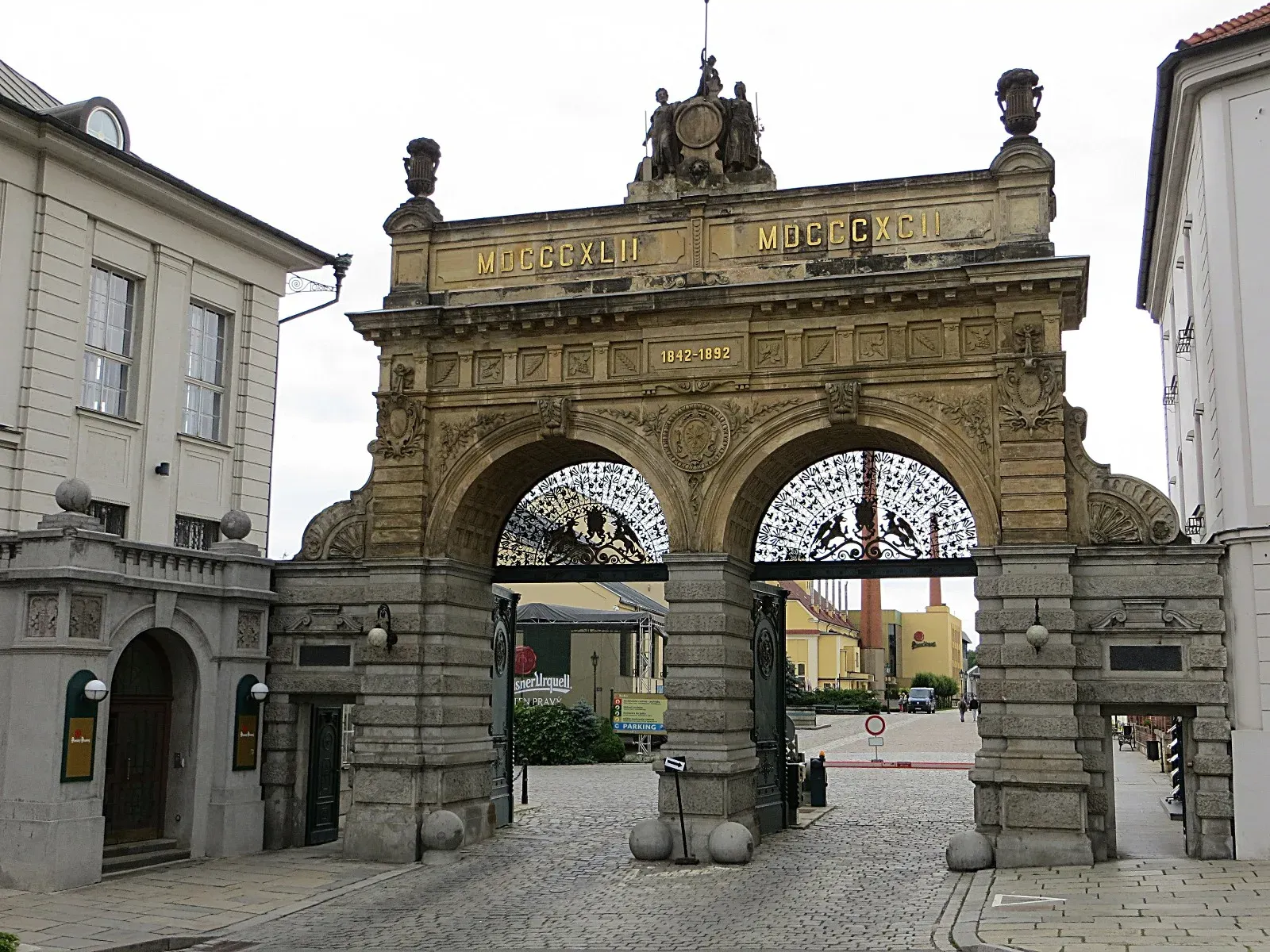The gateway of the Pilsner Urquell brewery in Plzeň, with the years 1842 and 1892 on its arch